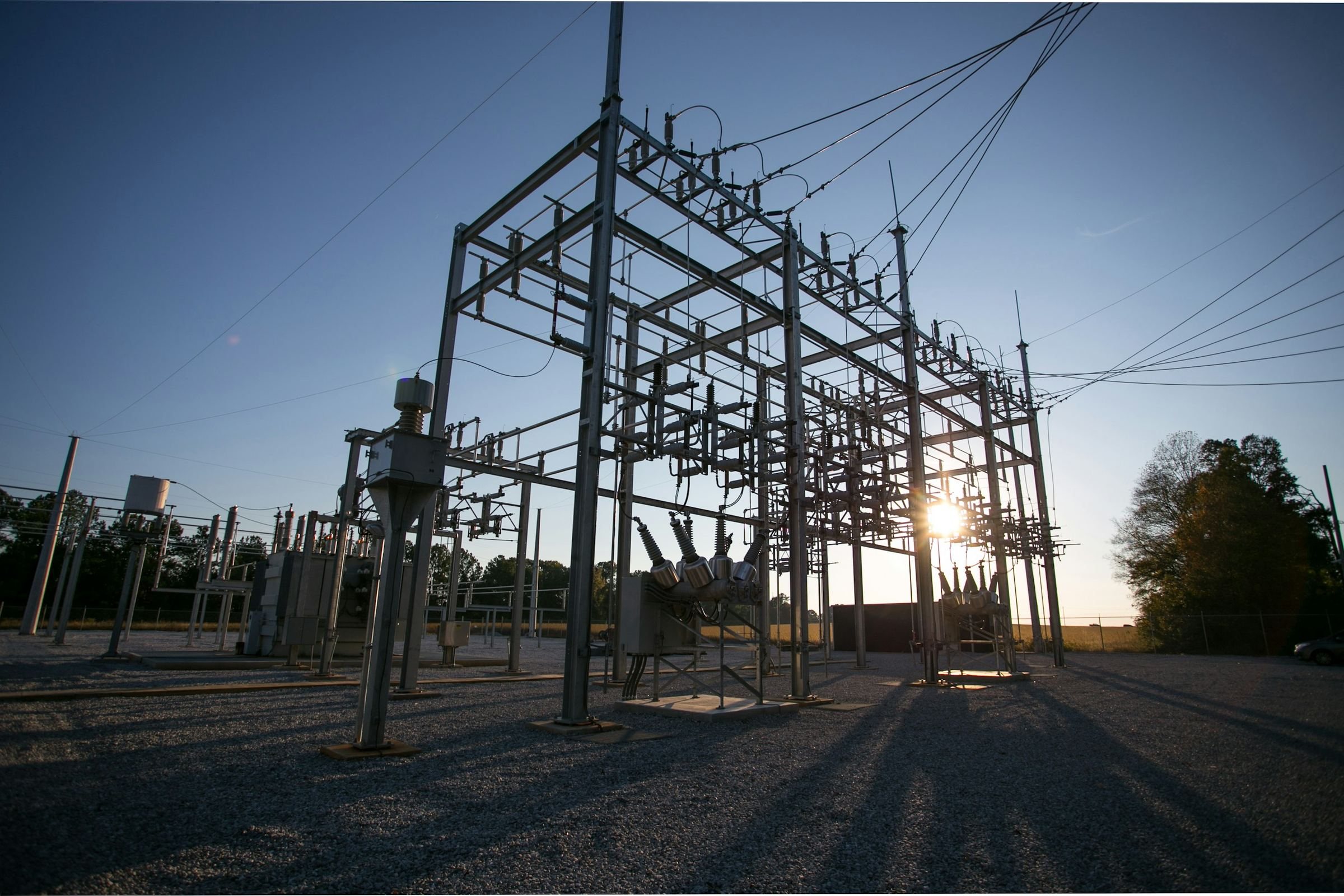 Electrical substation steelwork against a clear sky