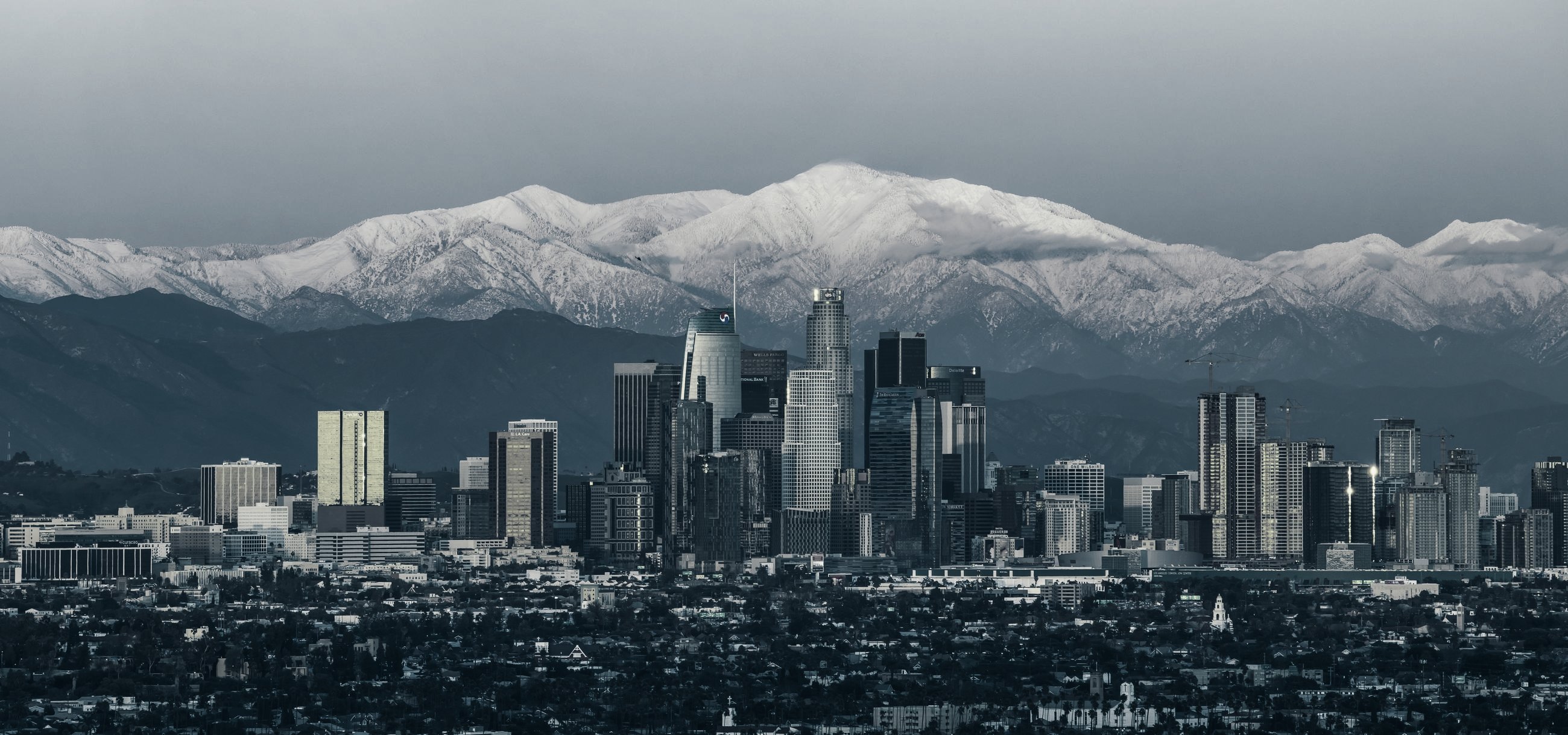 Downtown Los Angeles at sunset, with snow on Mount Baldy behind